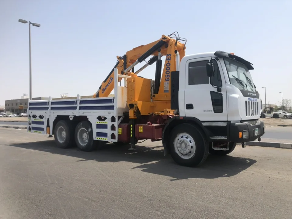Pole Star white Astra crane truck with a Cormach crane mounted behind the cab and a long cargo bed.