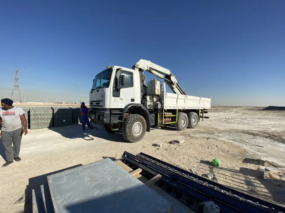 Pole Star Iveco crane truck on sandy ground at a worksite.