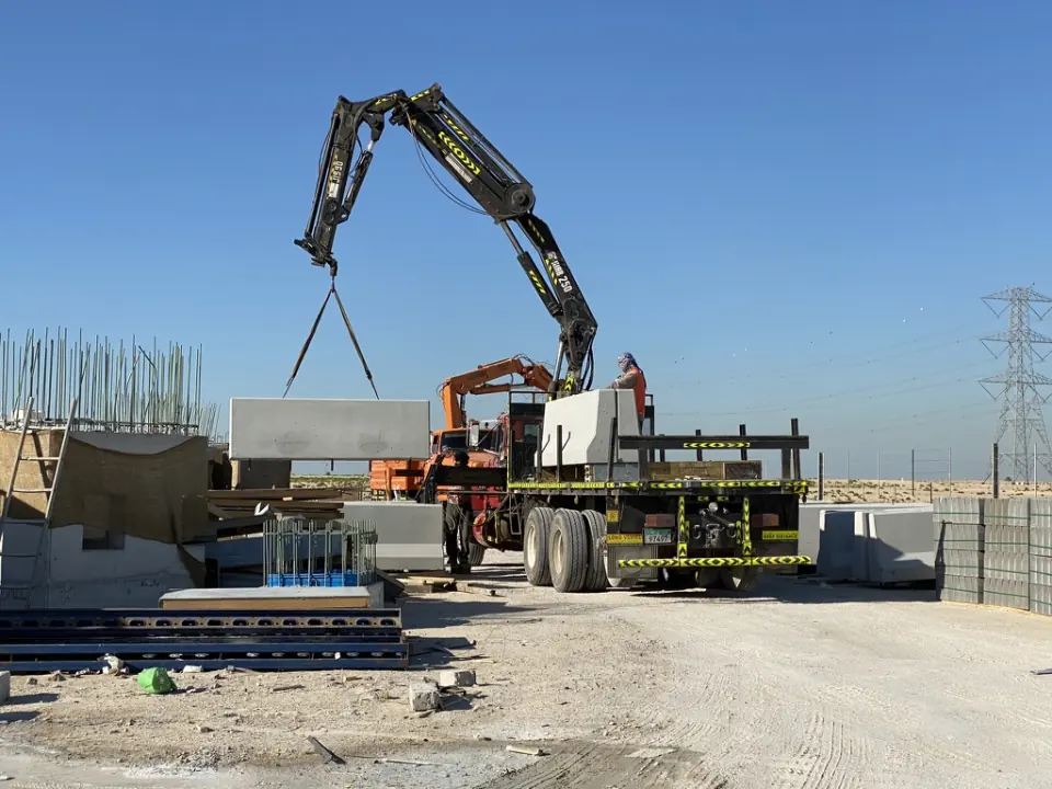 A Pole Star crane truck unloading a precast concrete section on site.